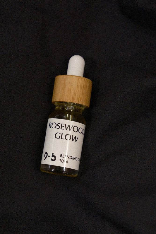 Single 9to5 Studios Rosewood Glow Blending Oil 10ml glass dropper bottle on black fabric