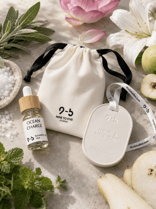 9to5 Studios white ceramic diffuser with Ocean Charge oil beside fresh lotus, mint, pear, and sea salt botanicals