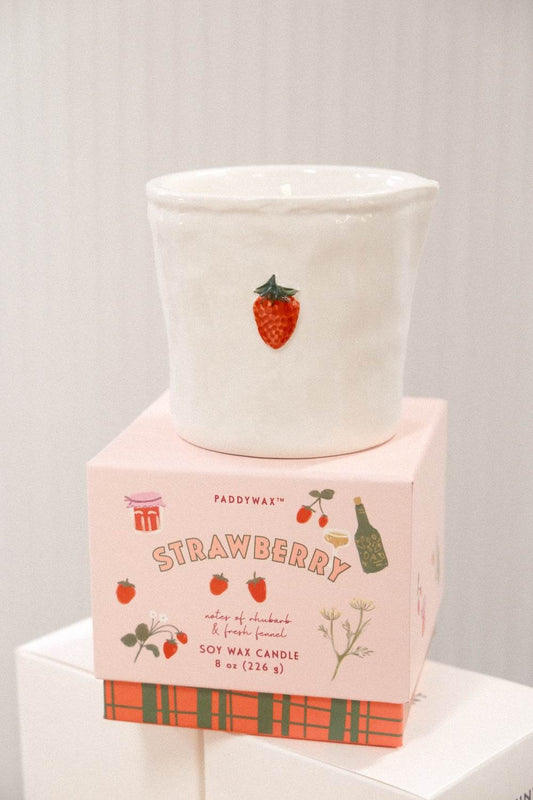 Close-up of Paddywax Strawberry soy wax candle showing textured ceramic surface and label