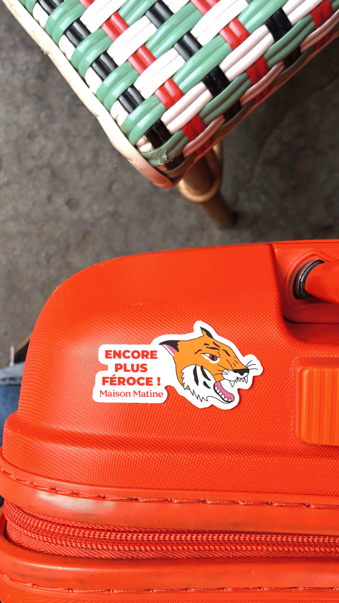 Maison Matine tiger sticker on orange suitcase for travel fragrance