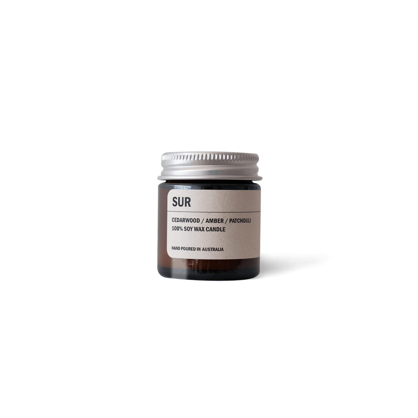 Posie Candle in amber glass jar with cedarwood, amber, and patchouli scent notes