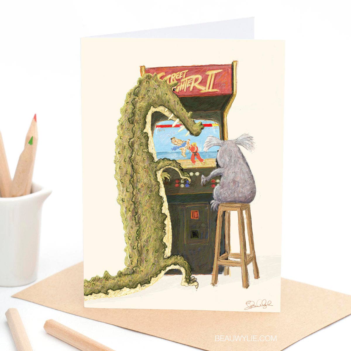 Street Fight greeting card by Beau Wylie for 9to5 Studios featuring green crocodile and koala on arcade cabinet, A6 recycled white cardstock