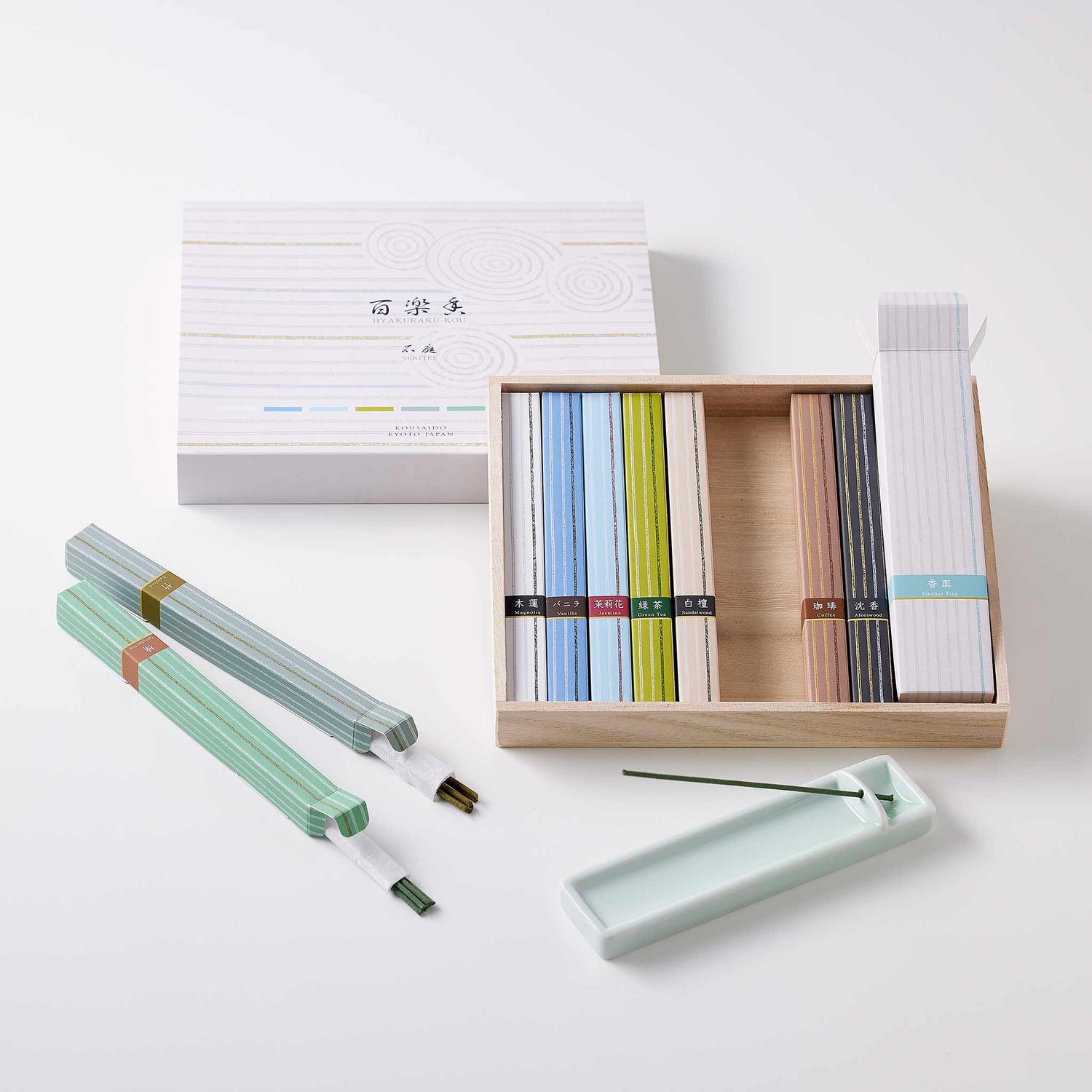 Japanese incense collection in natural wood gift box with striped paper packaging and ceramic holder