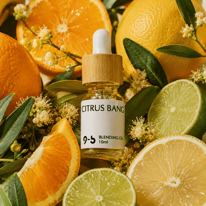 Citrus Bang Blending Oil 10ml surrounded by fresh orange lime lemon slices