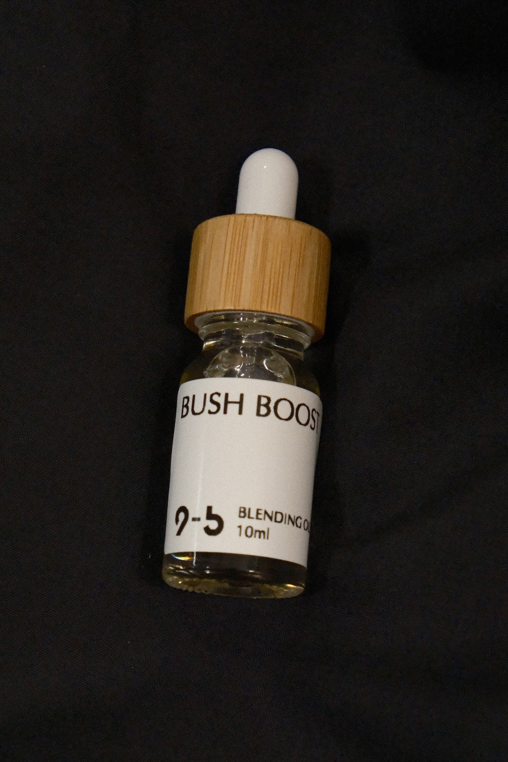 9to5 Studios Bush Boost Blending Oil 10ml glass dropper bottle on solid black background