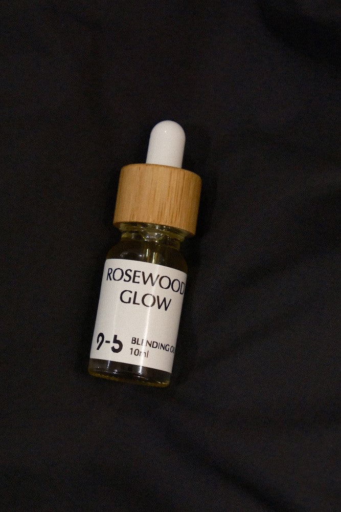 Single 9to5 Studios Rosewood Glow Blending Oil 10ml glass dropper bottle on black fabric