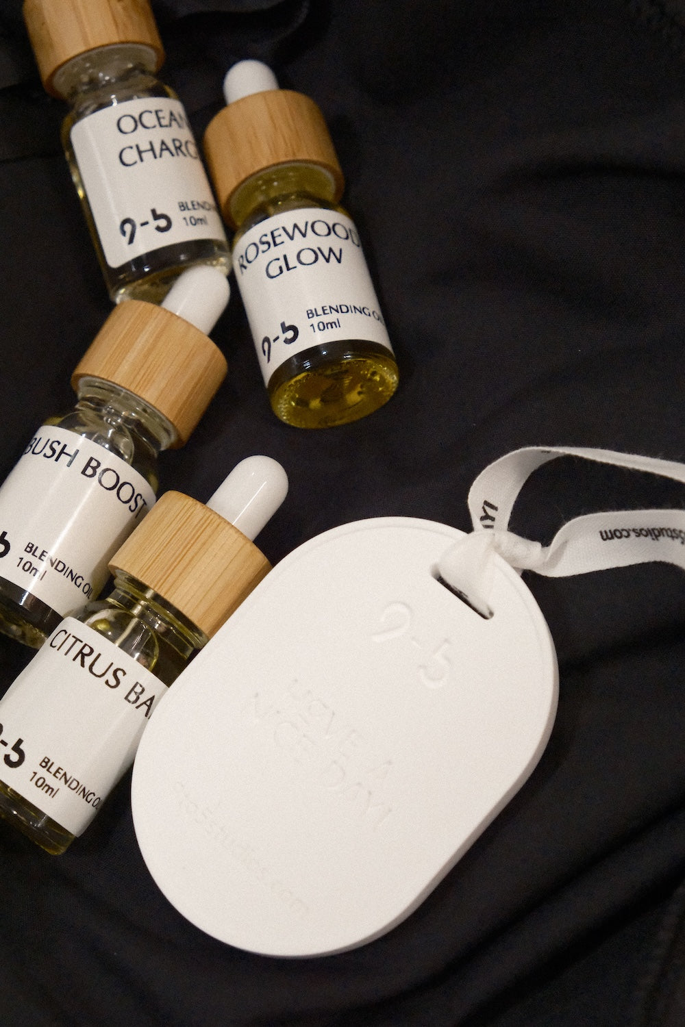 Four 9to5 Studios blending oils with ceramic tag and ribbon