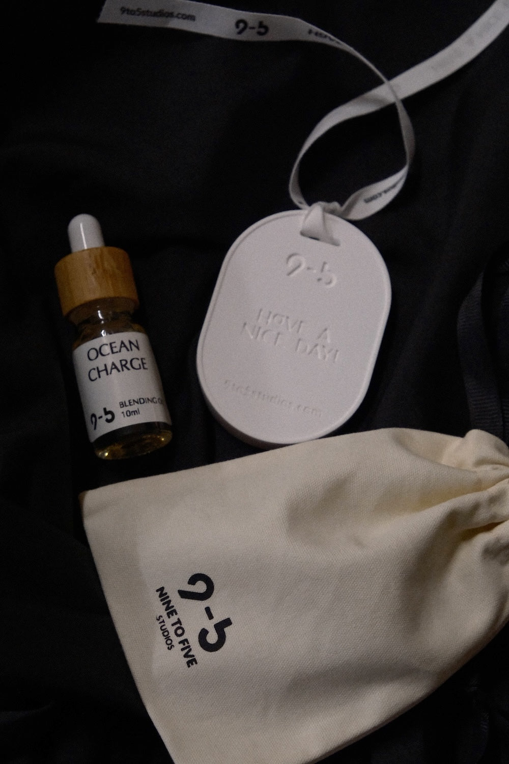 Ocean Charge oil set in cream pouch from 9to5 Studios with ceramic tag