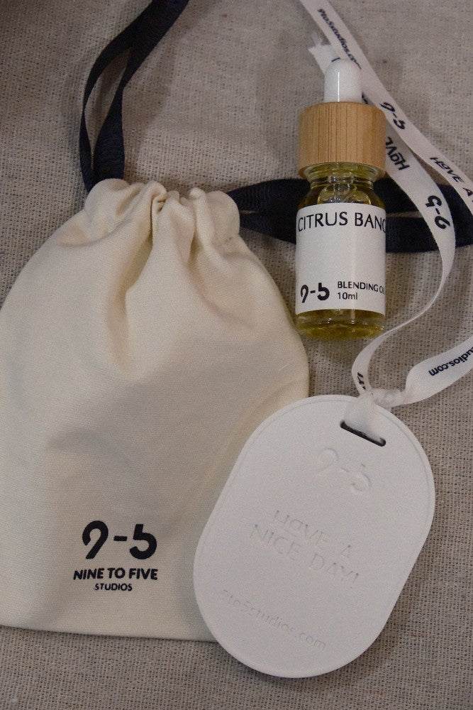 9to5 Studios Citrus Bang oil gift set with pouch on beige textured background