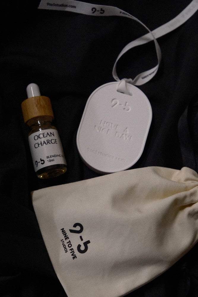 Ocean Charge oil set in cream pouch from 9to5 Studios with ceramic tag