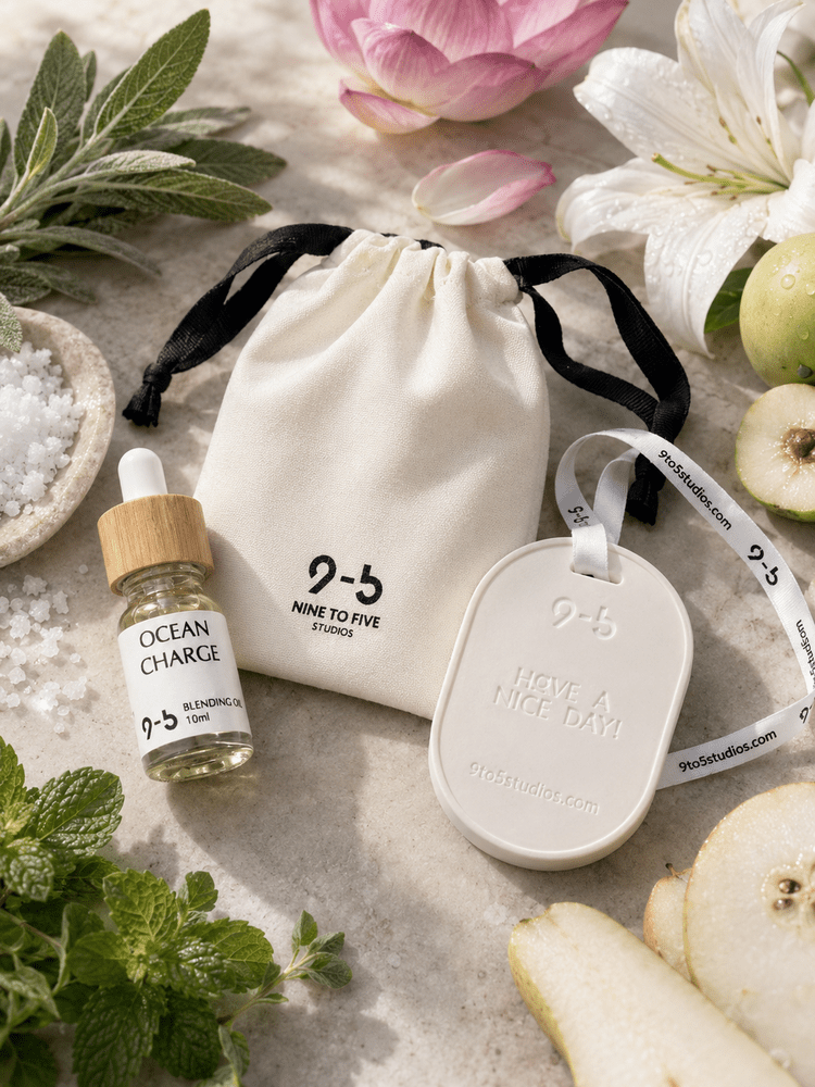 9to5 Studios white ceramic diffuser with Ocean Charge oil beside fresh lotus, mint, pear, and sea salt botanicals