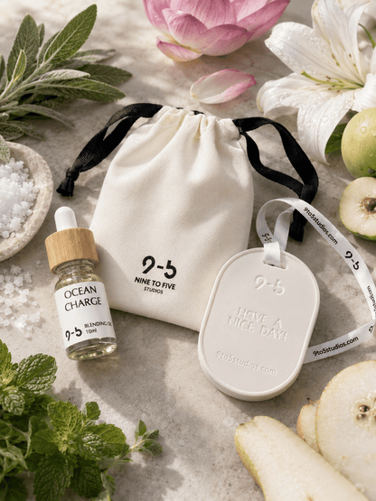 9to5 Studios white ceramic diffuser with Ocean Charge oil beside fresh lotus, mint, pear, and sea salt botanicals