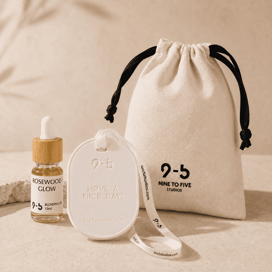9to5 Studios white oval ceramic stone diffuser with bamboo dropper oil bottle and cream drawstring pouch flat lay