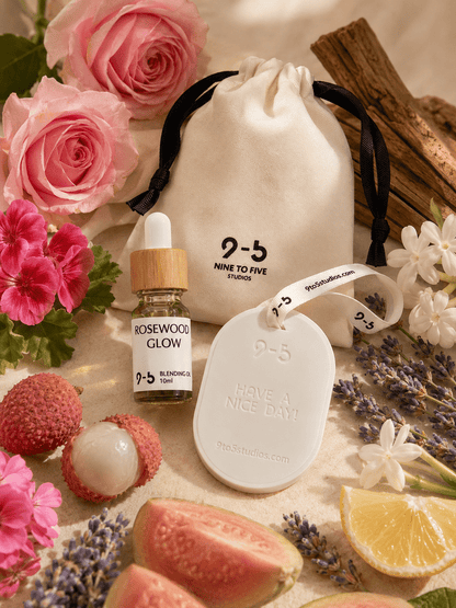 9to5 Studios Rosewood Glow ceramic diffuser surrounded by rose geranium lavender lychee guava scent elements