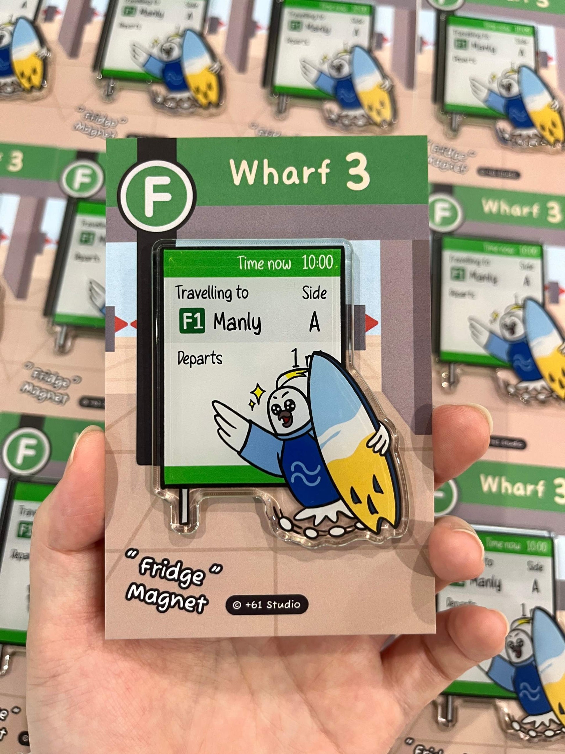 Hand-held view of +61 Studio Manly ferry cockatoo magnet by 9to5 Studios