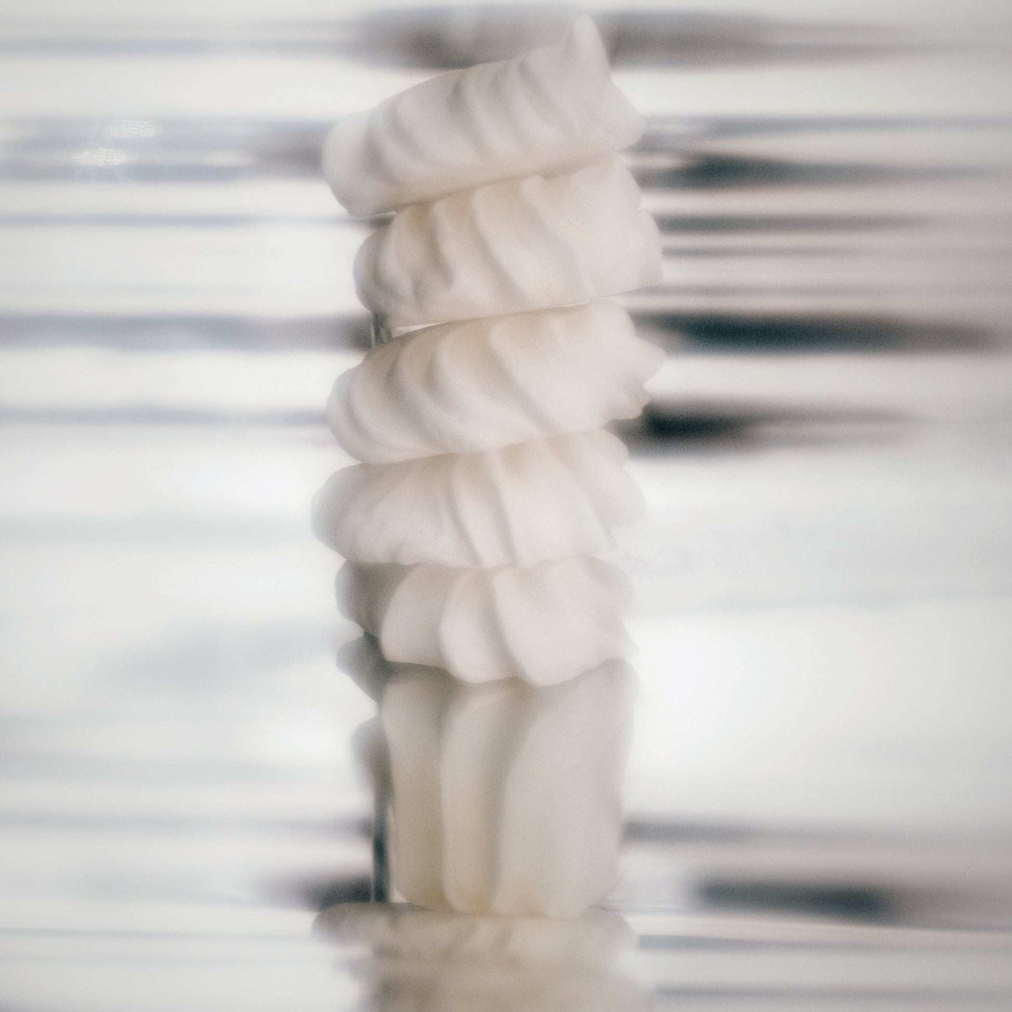 Abstract swirled cream texture representing Odesse Crème Santal iris vanilla notes at 9to5 Studios