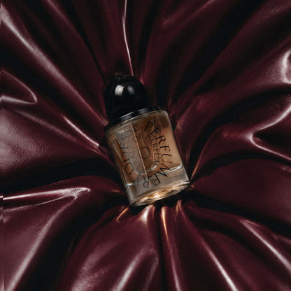 Odesse Deep Orchid amber extrait de parfum bottle on burgundy satin at 9to5 Studios