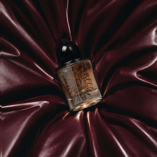 Odesse Deep Orchid amber extrait de parfum bottle on burgundy satin at 9to5 Studios