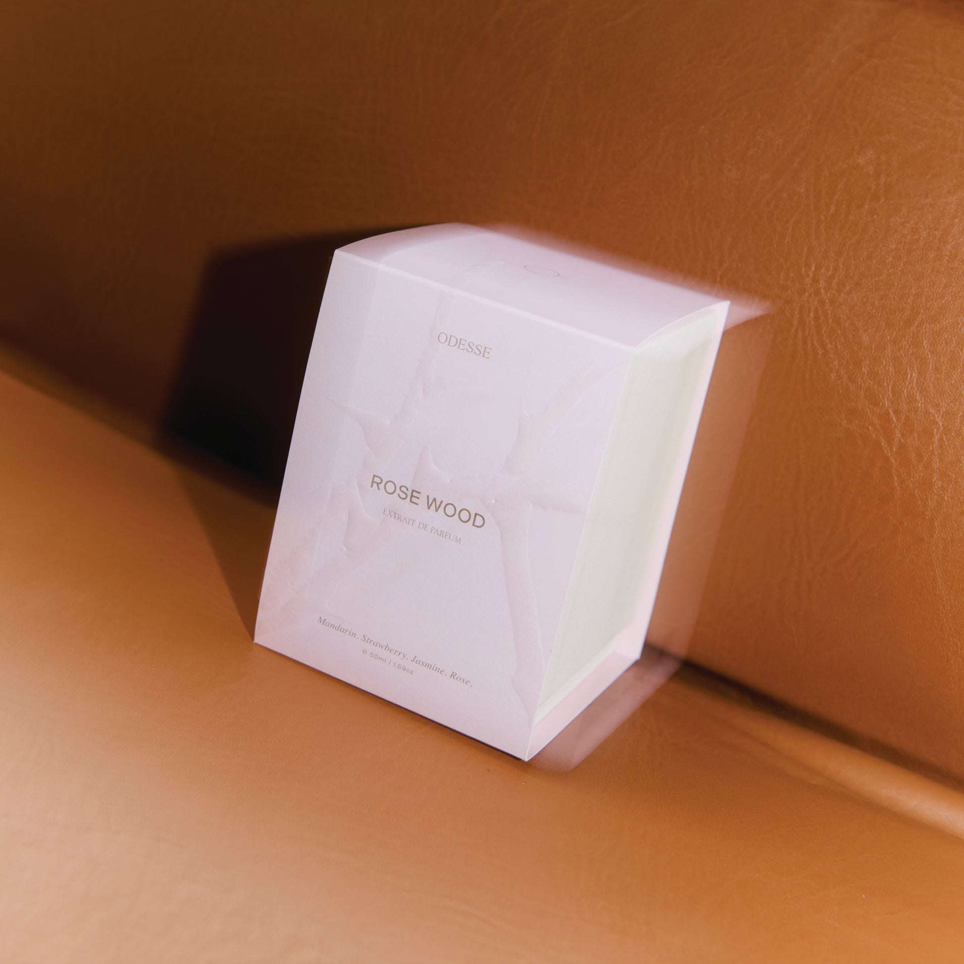 White Odesse Rose Wood box showing scent notes on leather surface by 9to5 Studios