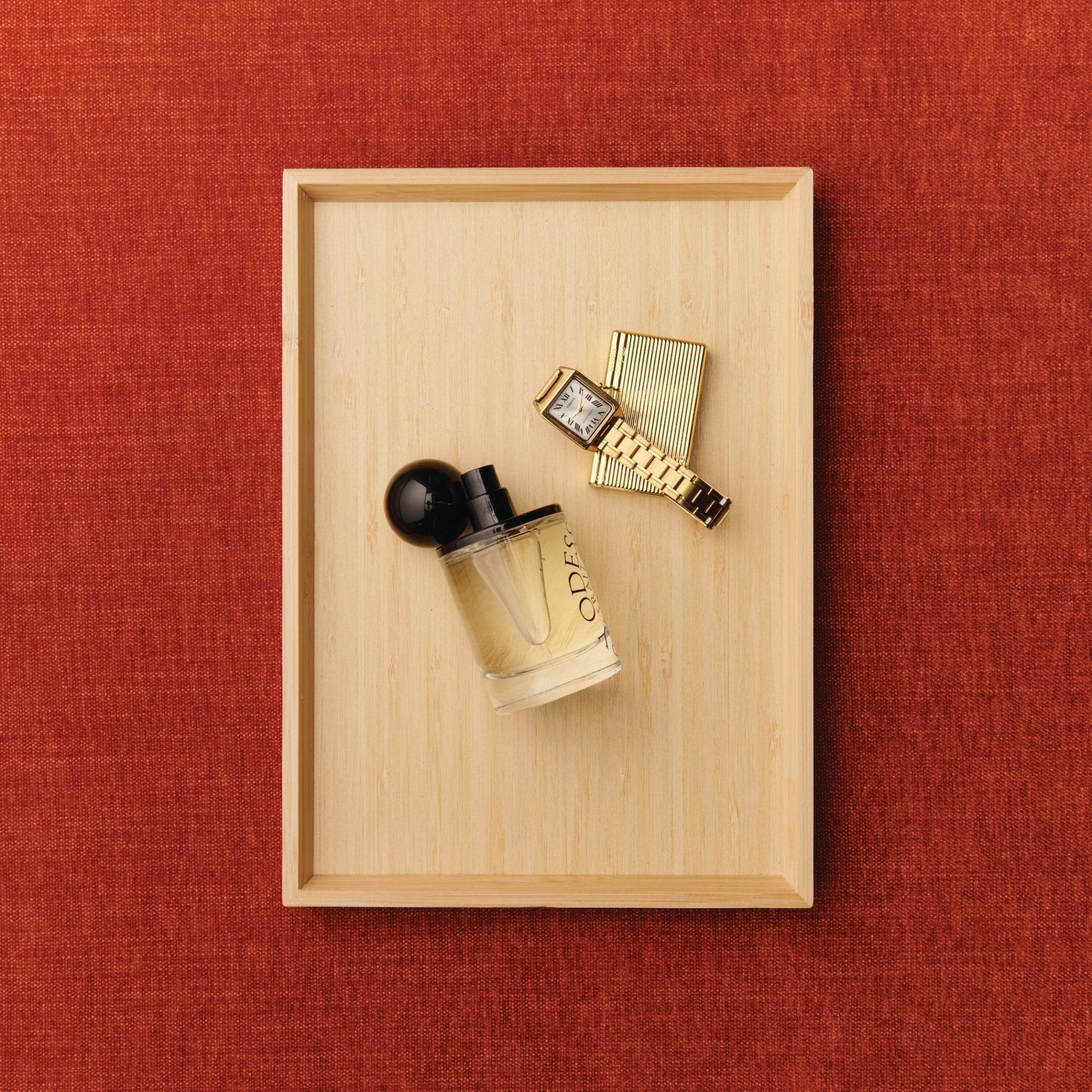 Odesse perfume bottle with gold watch and cigarette case at 9to5 Studios