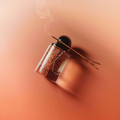 Odesse The Valley perfume bottle with lit incense stick on terracotta surface at 9to5 Studios