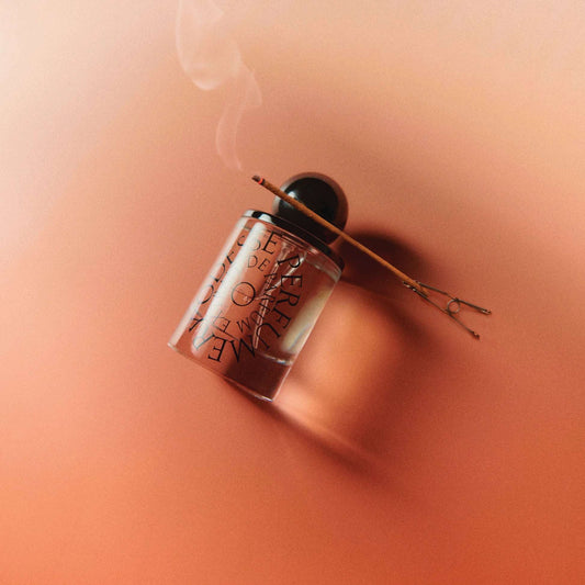 Odesse The Valley perfume bottle with lit incense stick on terracotta surface at 9to5 Studios