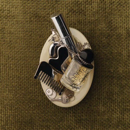 Odesse The Valley perfume flat lay with vintage accessories in ceramic dish at 9to5 Studios