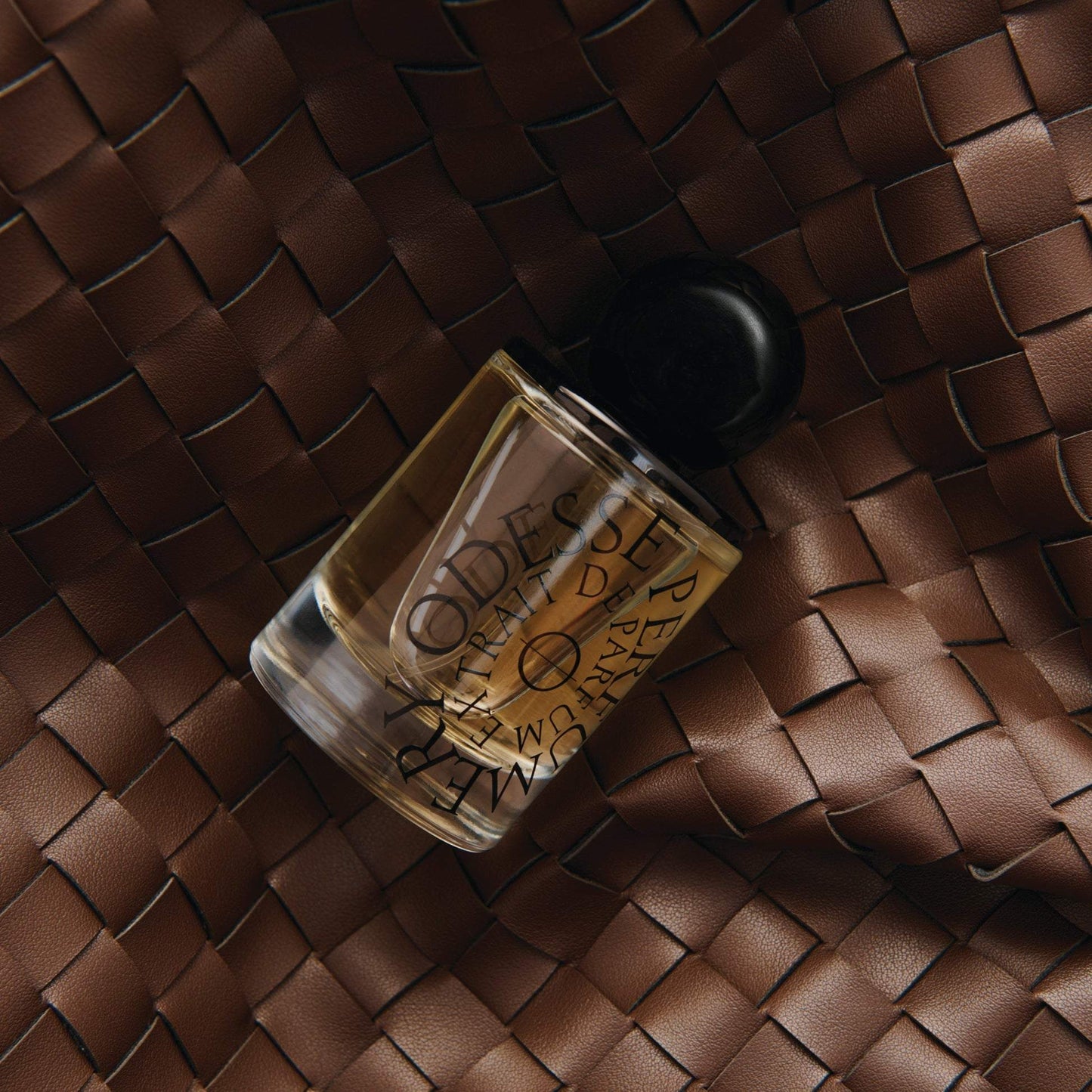 Odesse The Valley perfume bottle on brown woven leather diamond pattern at 9to5 Studios