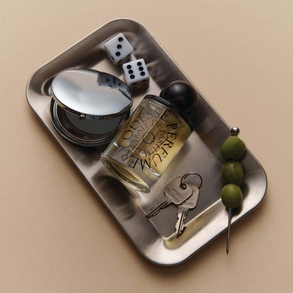 Odesse The Valley perfume bottle on steel tray with dice and keys at 9to5 Studios