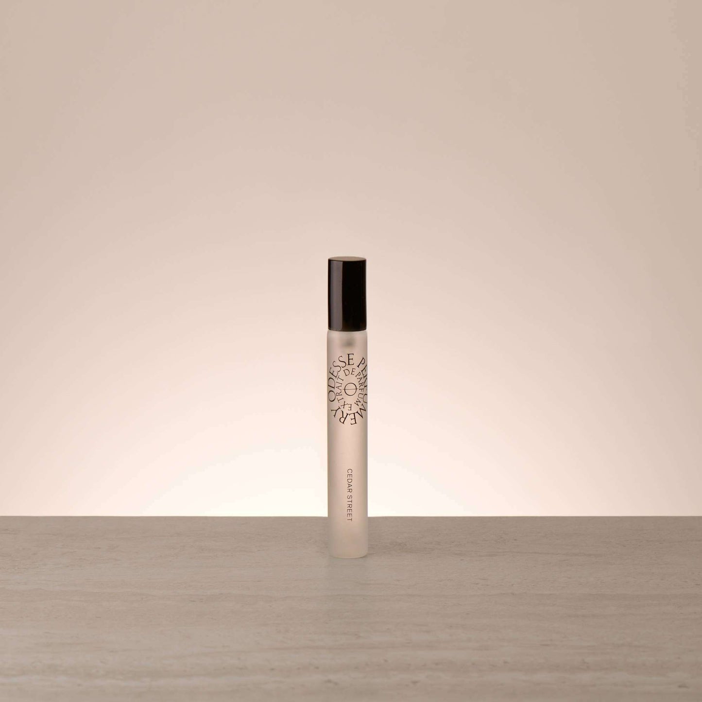 Odesse Travel Size Cedar Street Extrait De Parfum rollerball in frosted glass with matte black cap by 9to5 Studios