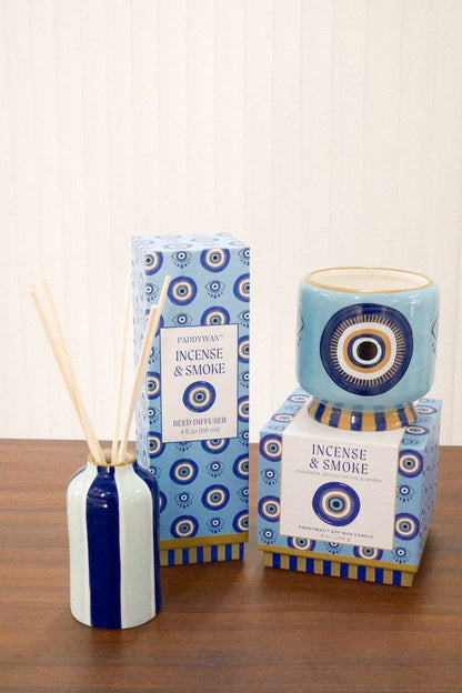 Paddywax Incense & Smoke reed diffuser paired with matching soy wax candle on wooden surface