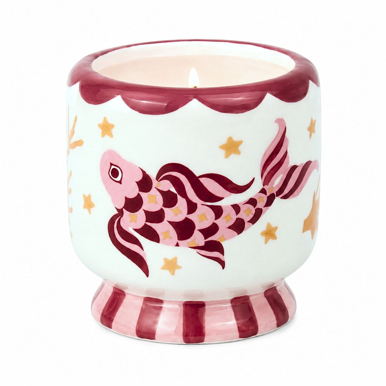Lit Paddywax ceramic Koi candle featuring hand-painted pink maroon fish and gold seaweed