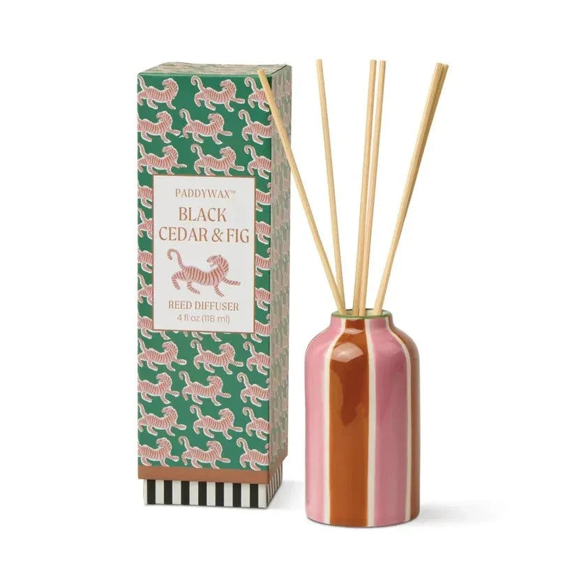 Paddywax Black Cedar & Fig Reed Diffuser in glossy pink orange white striped ceramic with bamboo reeds and tiger box