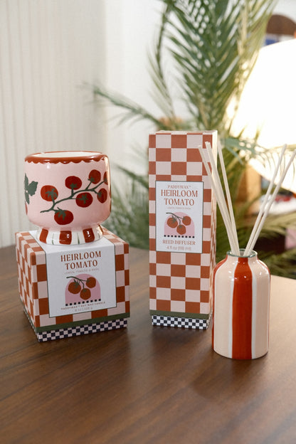 Paddywax Heirloom Tomato Reed Diffuser displayed with pink tomato candle and greenery