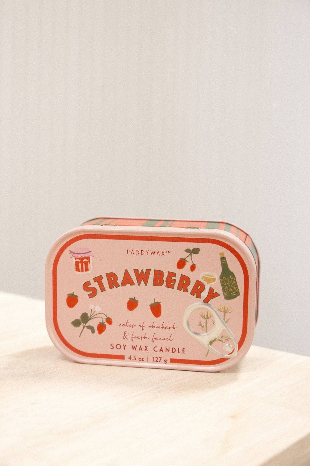 Front view Paddywax Strawberry soy wax candle featuring hand-drawn fruit illustrations on peach label