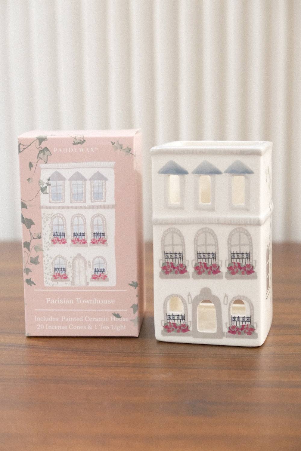 Front view of Paddywax white ceramic Parisian townhouse incense holder featuring arched windows, black iron railings, and included incense cones