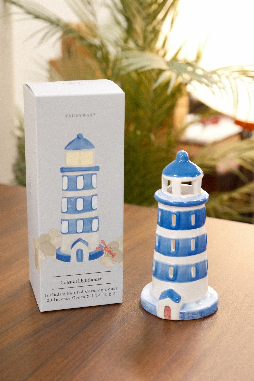 PADDYWAX Coastal Lighthouse ceramic incense holder on wood with original retail box showing 20 incense cones and palm foliage