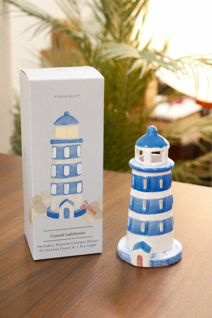 PADDYWAX Coastal Lighthouse ceramic incense holder on wood with original retail box showing 20 incense cones and palm foliage