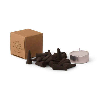 PADDYWAX branded kraft paper recycling box with scattered Palo Santo incense cones and silver tea light candle