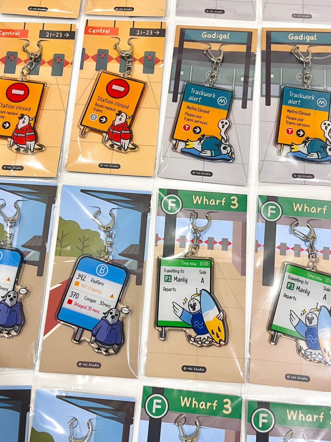 9to5 Studios retail display of +61 Studio acrylic keychains including Manly ferry design with branded backing cards