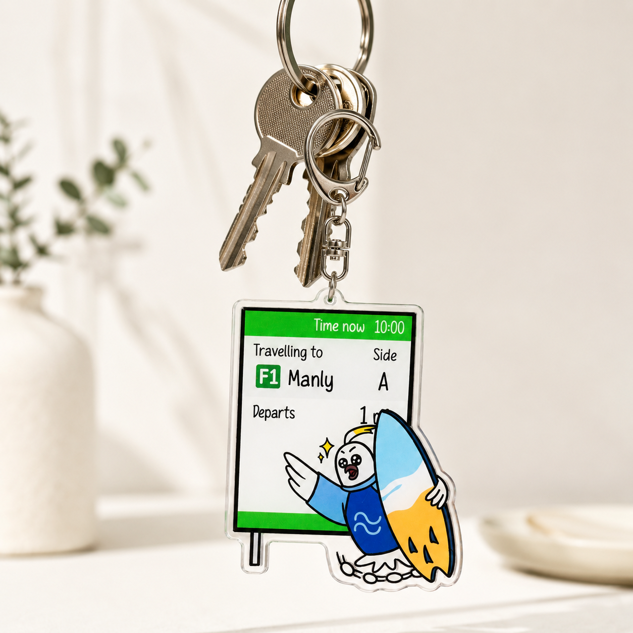 9to5 Studios +61 Studio cockatoo surfboard keychain on keys lifestyle shot