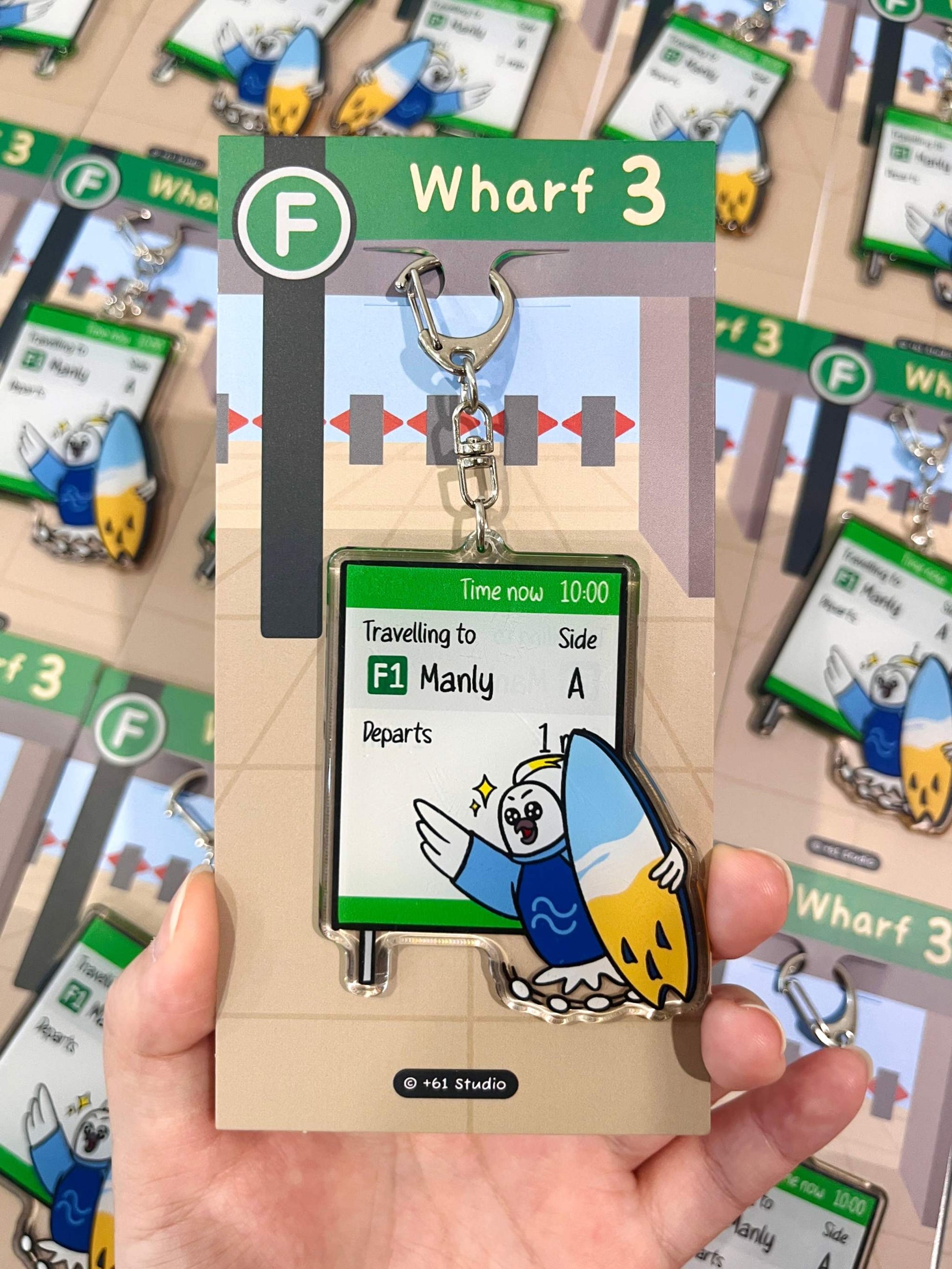 +61 Studio Ferry keychain featuring a happy cockatoo with surfboard running to catch the Manly ferry on premium optical acrylic