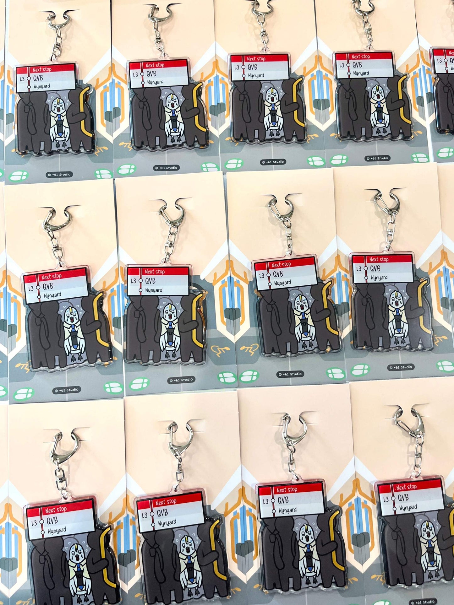 Bulk display of 9to5 Studios Australian souvenir keychains arranged in rows on uniform backing cards