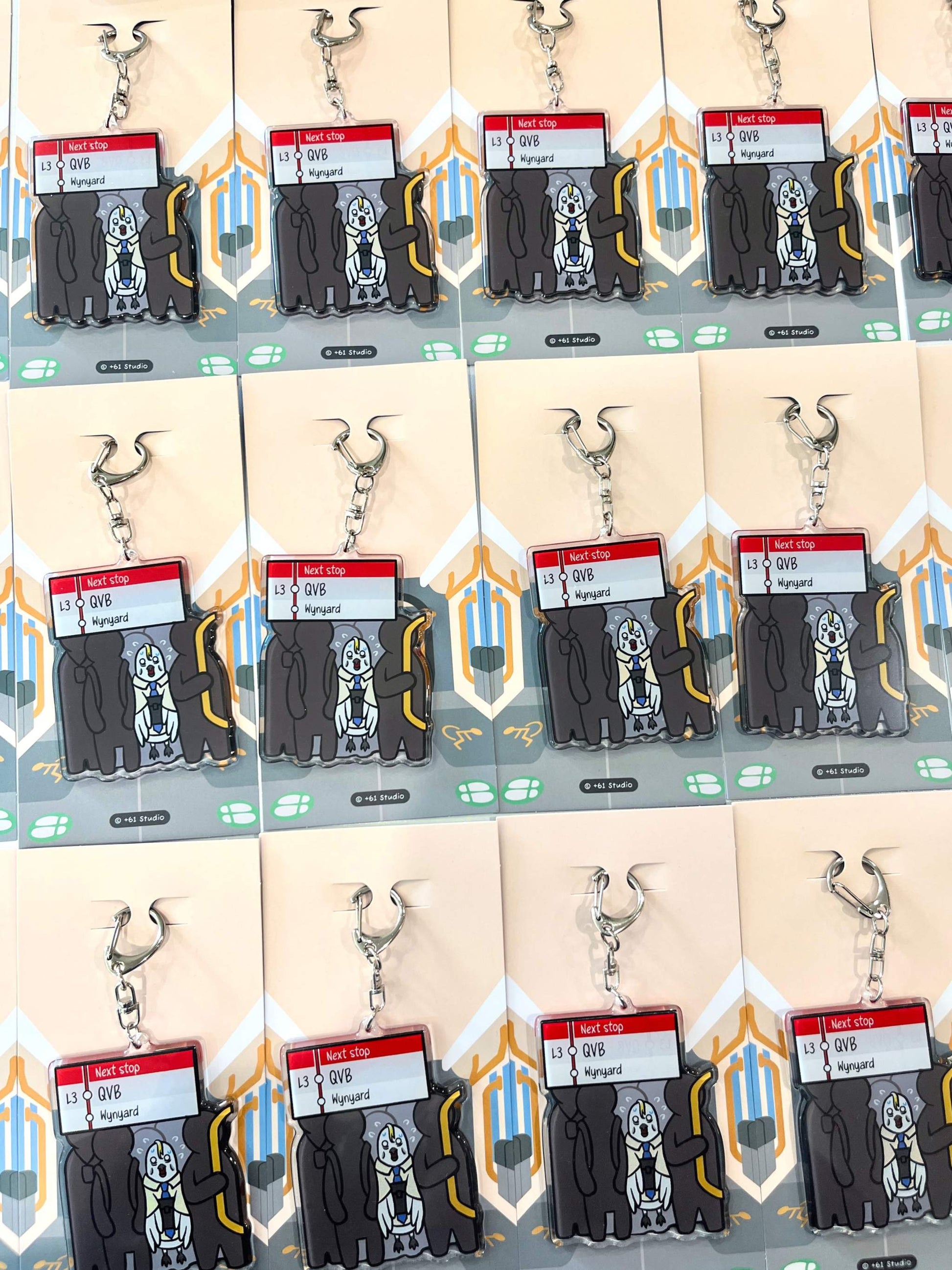 Bulk display of 9to5 Studios Australian souvenir keychains arranged in rows on uniform backing cards