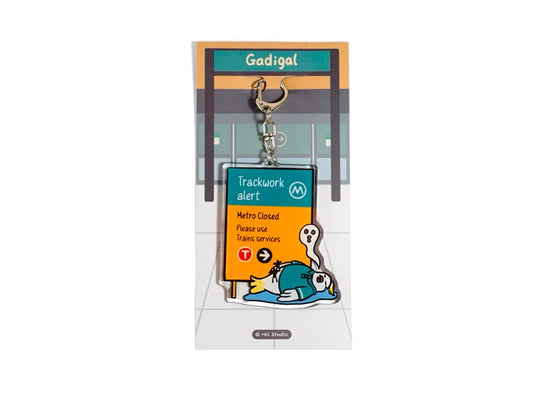 +61 Studio Metro trackwork alert keychain featuring a flat white cockatoo illustration on premium optical acrylic with metal clasp