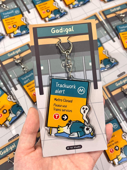 +61 Studio Metro trackwork alert keychain featuring a flat cockatoo illustration on premium optical acrylic with double-sided print and metal clasp