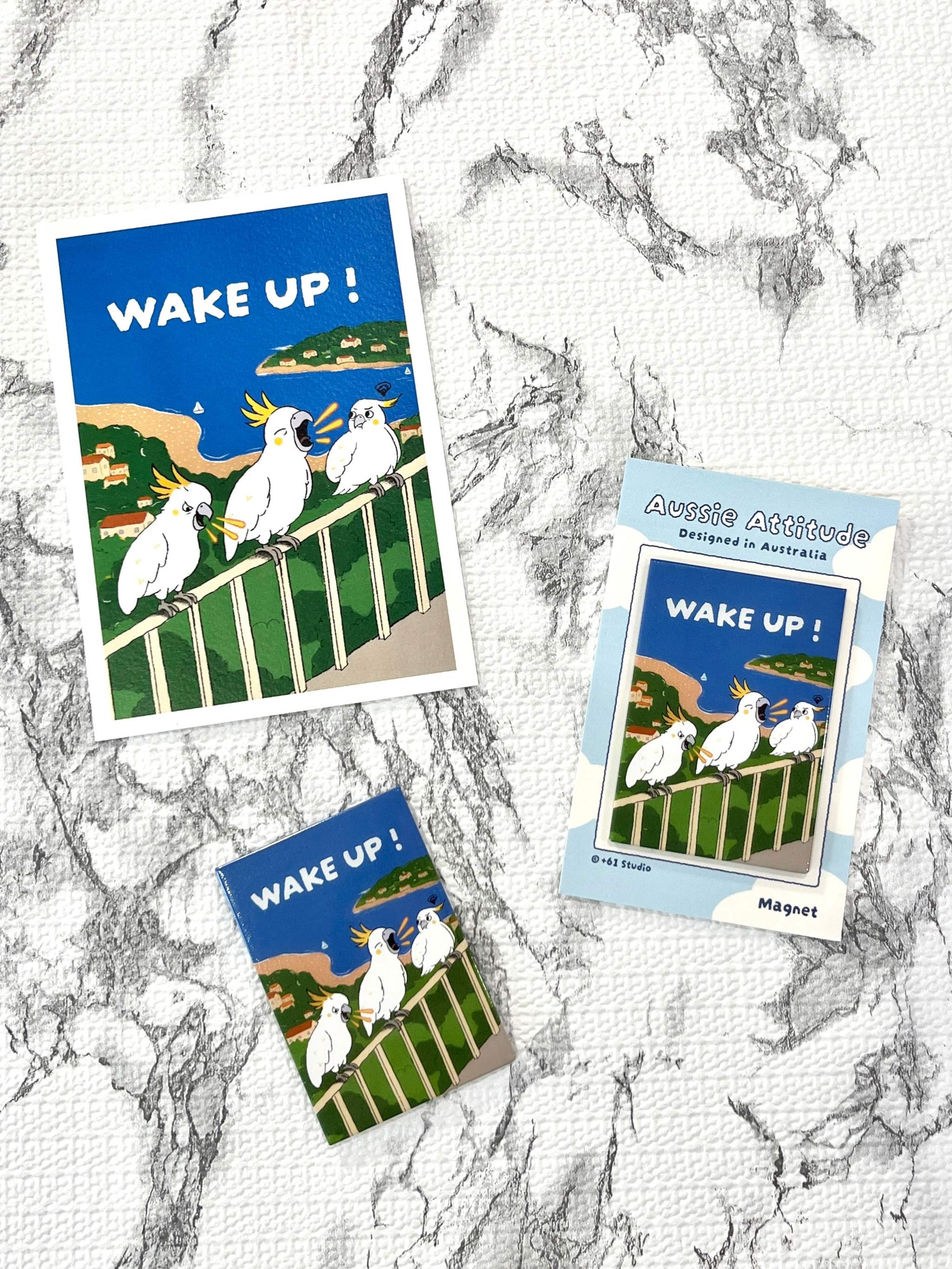 9to5 Studios flat lay of +61 Studio WAKE UP! postcard and Aussie Attitude magnet featuring screaming cockatoos design