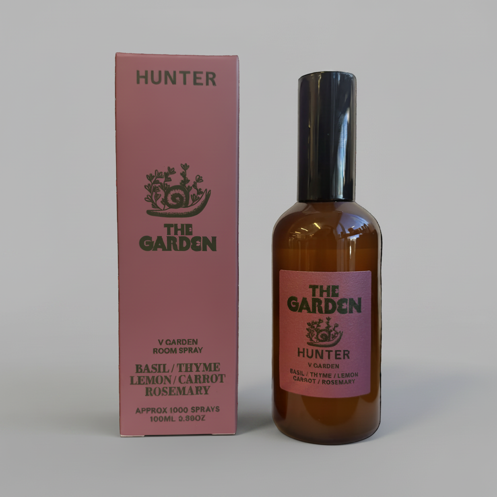 Hunter Candles room spray bottle and pink box against solid grey background