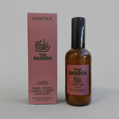 Hunter Candles room spray bottle and pink box against solid grey background