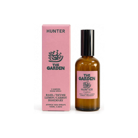 The Garden scented room spray bottle beside tall pink packaging box